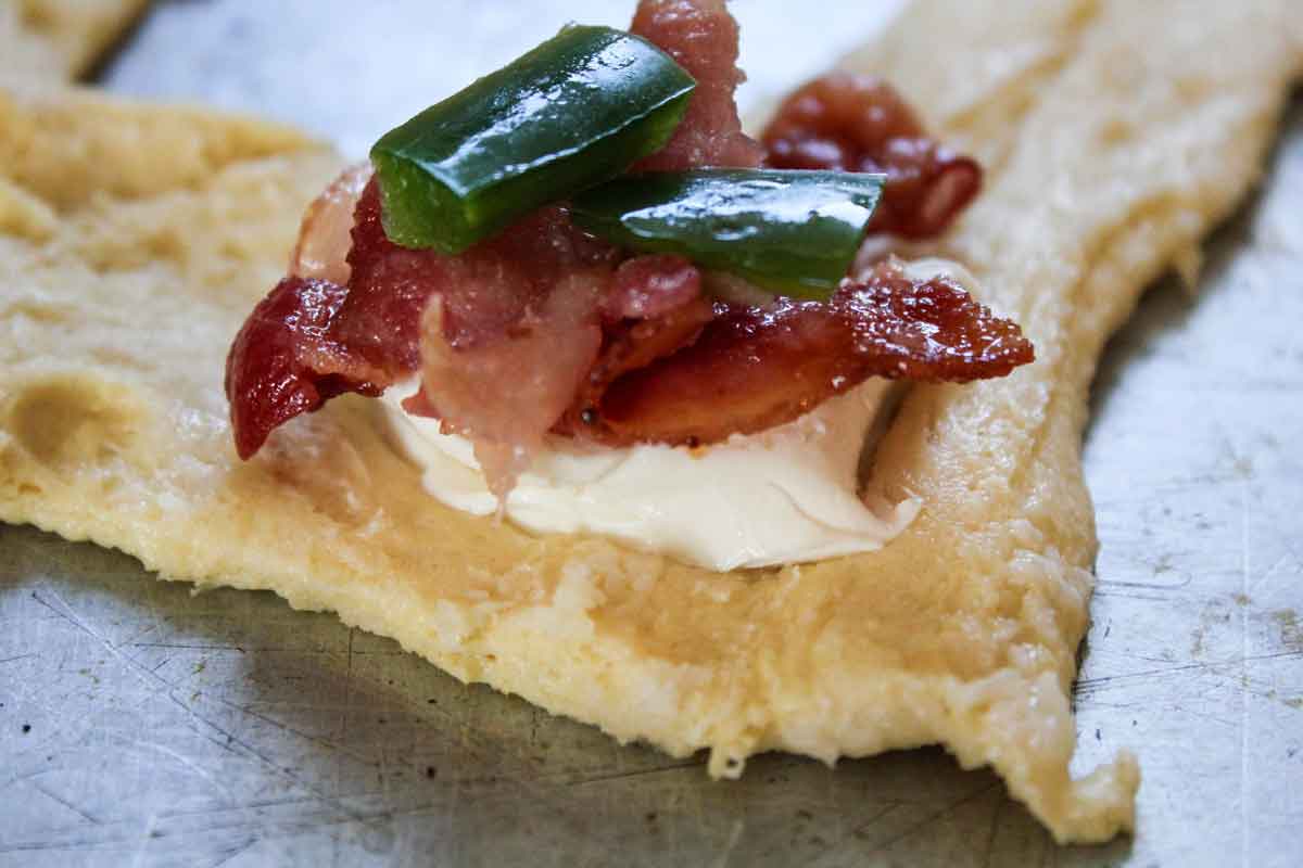cream cheese jalapenos and bacon on raw crescent dough for Jalapeno Poppers Crescents