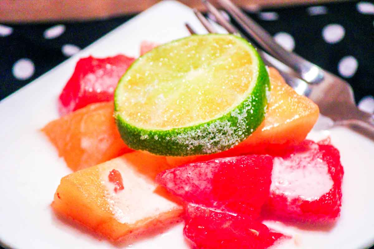 Watermelon Mango Salad with Coconut Lime Cream Dressing on a White Plate