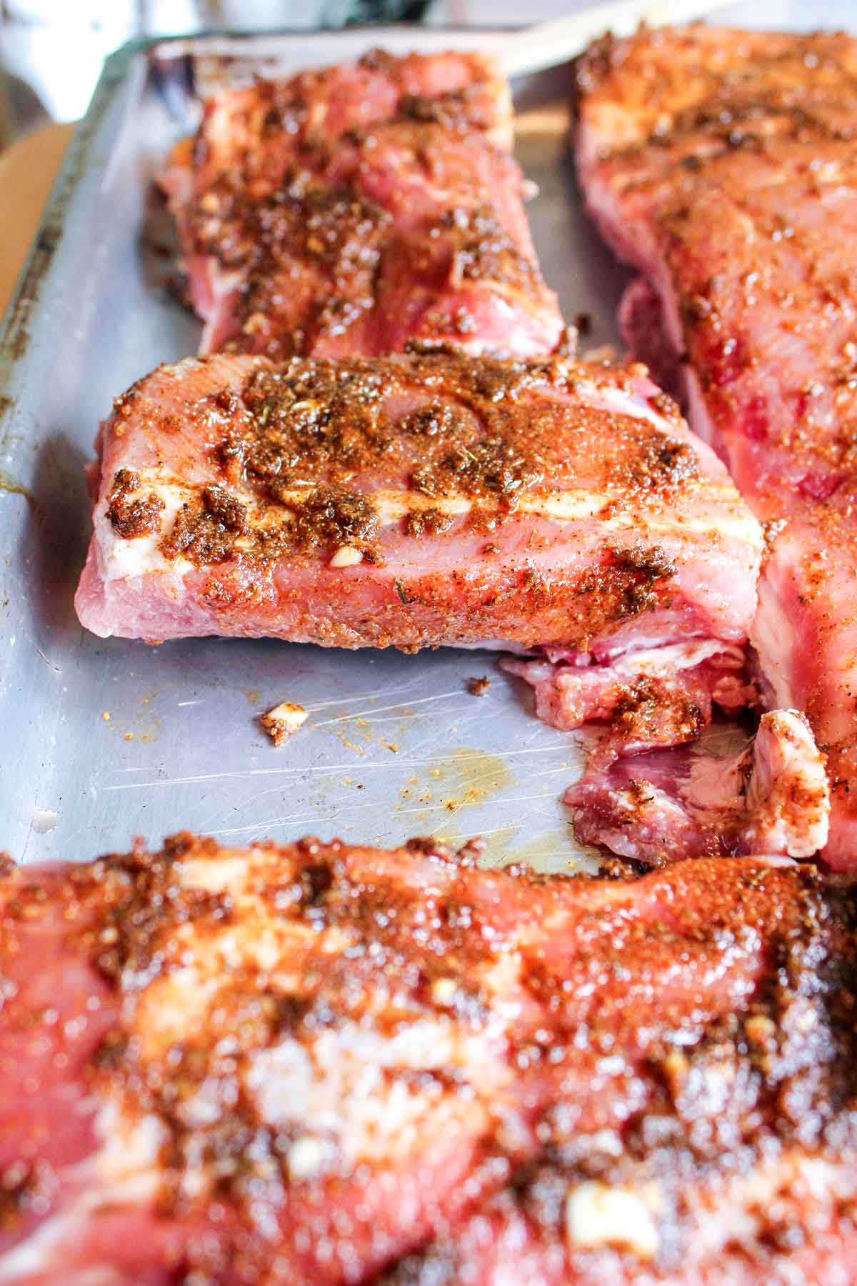 Easy Grilled Pork Ribs with rub on them about to go on grill