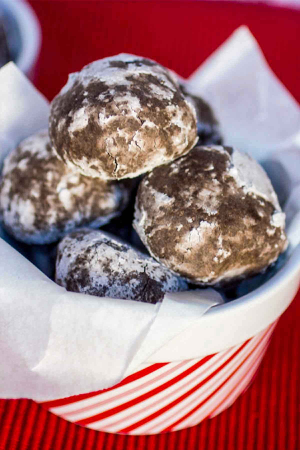 Chocolate Rum Balls in a candy cane print bucket.