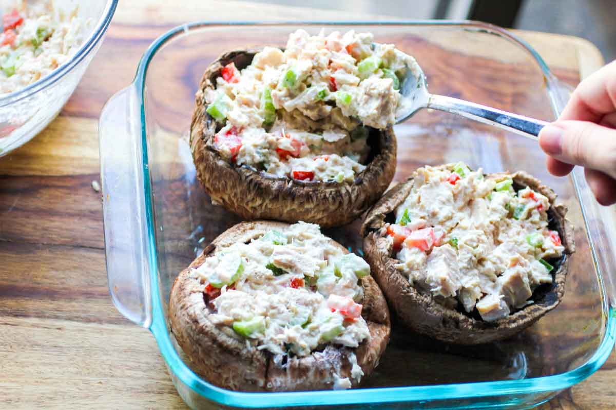 Tuna Stuffed Portabella Mushrooms lined up in a baking dish ready to in oven