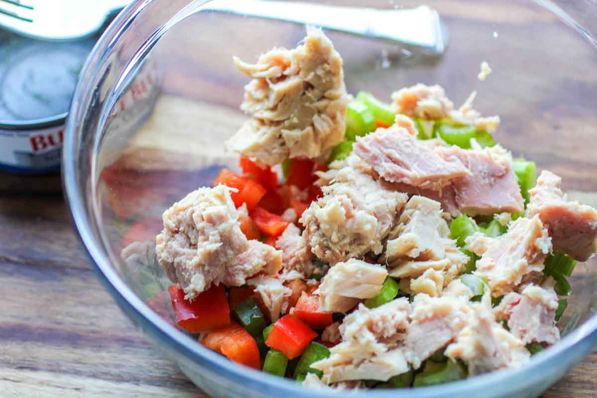 tuna and red and green peppers in a large glass bowl