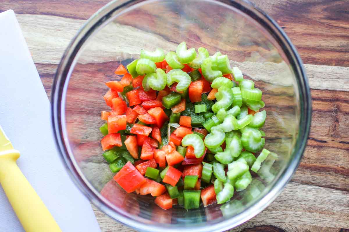 Step 2 celery in a bowl with chopped bell peppers