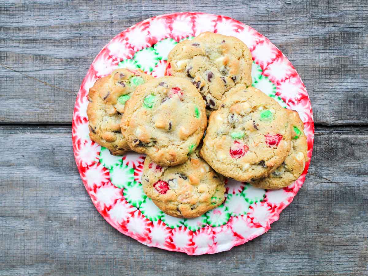 chocolate chip cookies with loads of cookie toppings and mix ins on a candy plate
