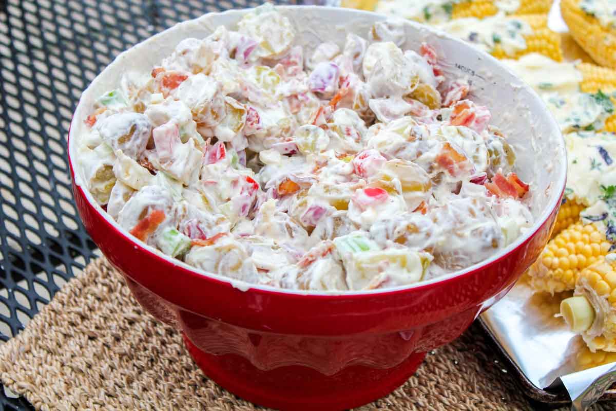 Creamy Potato Salad with Bacon in a Red Bowl