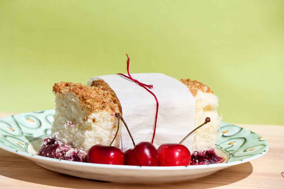 A slice of Cherry Crumb Cake on a pretty decorative plate