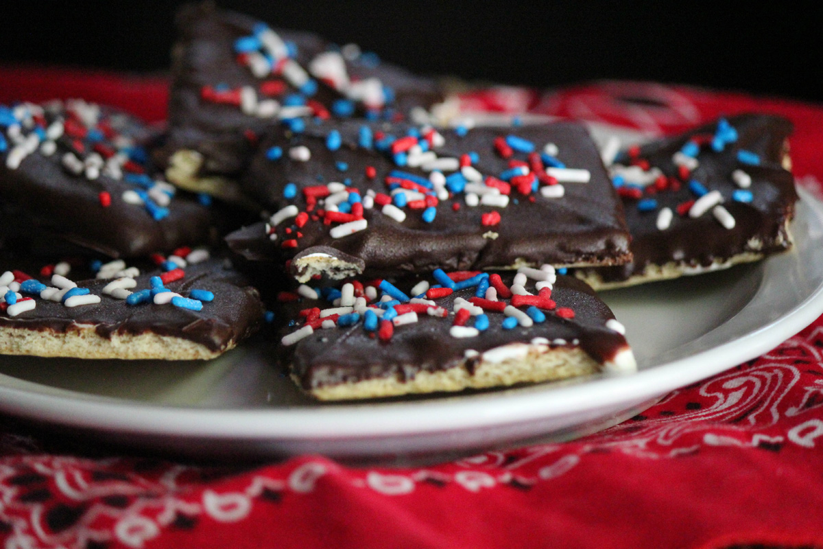 A bunch of smores cookies on a plate with sprinkles and a red bandana