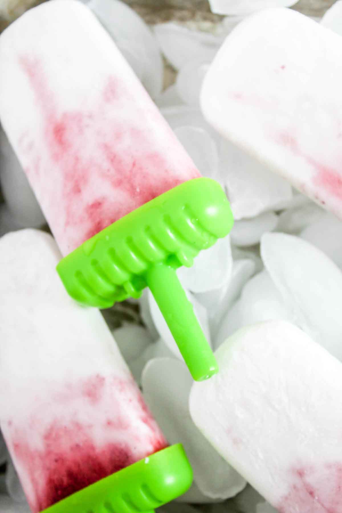 Strawberry Coconut Ice Pops close up with ice cubes