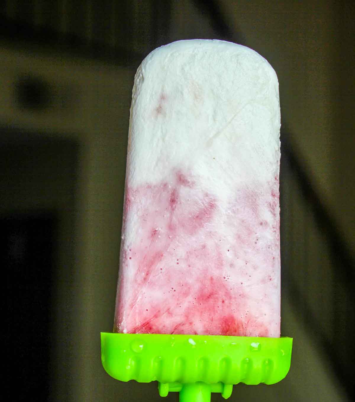 Strawberry Coconut Ice Pops extremely closeup in a hand