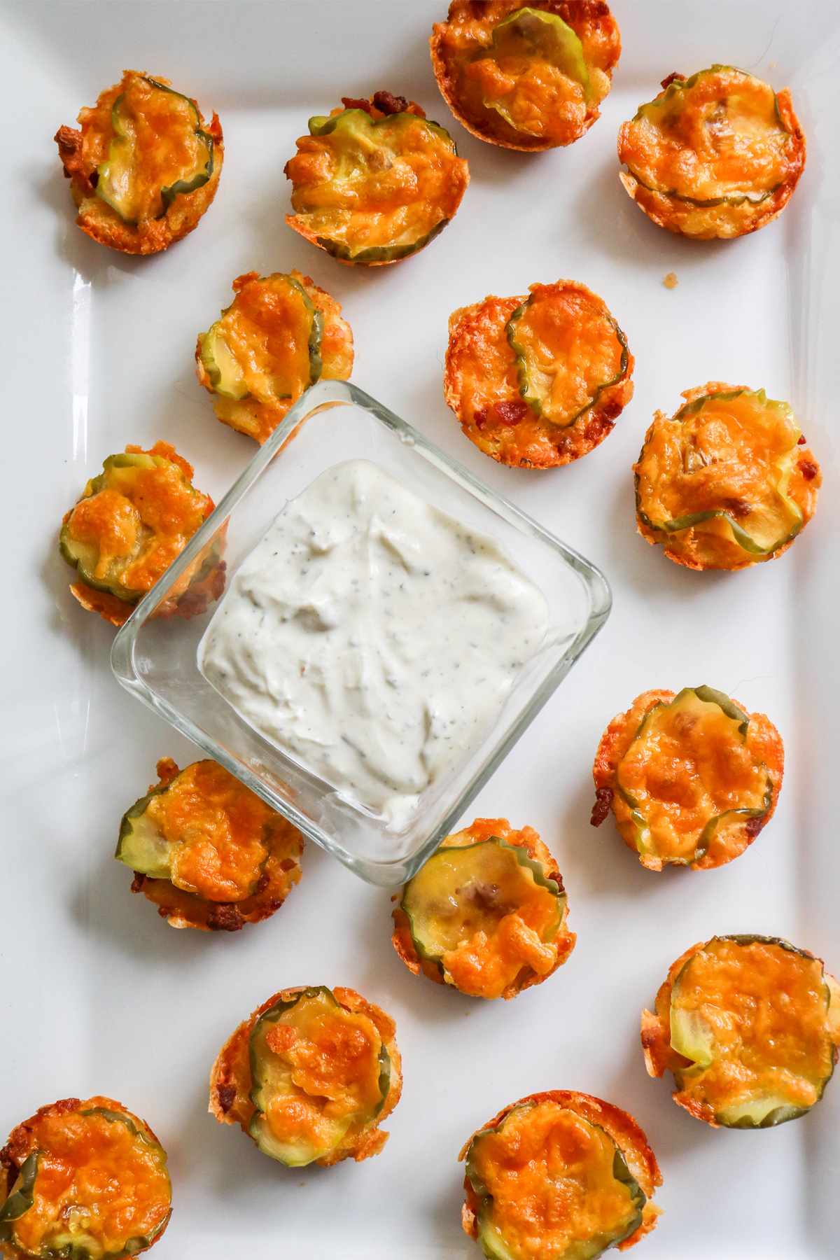 Tater Tot Oven Fried Pickle Chips on a White Platter with Ranch Dip