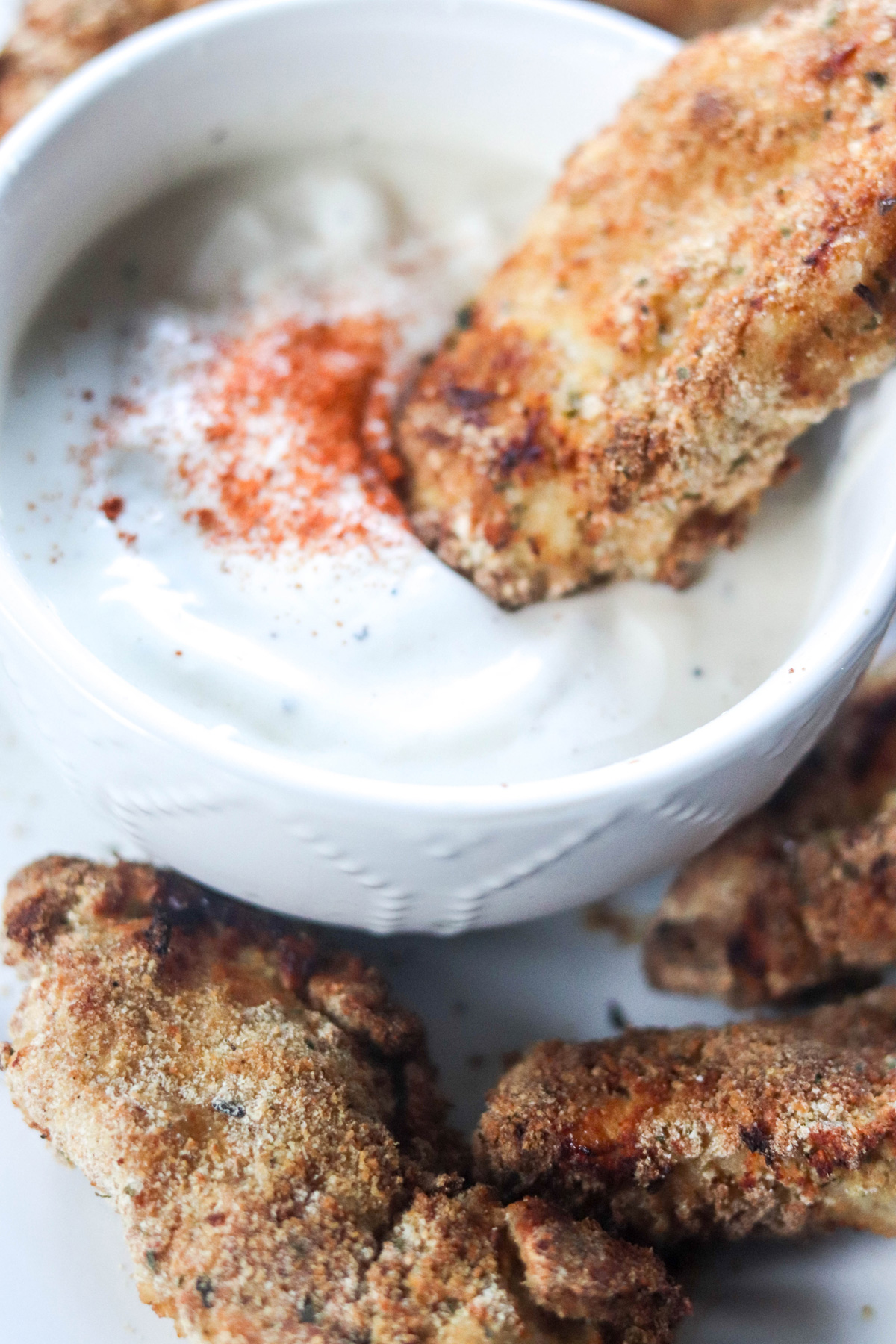 Dipping Air Fryer Chicken Fingers into a Ranch Dressing