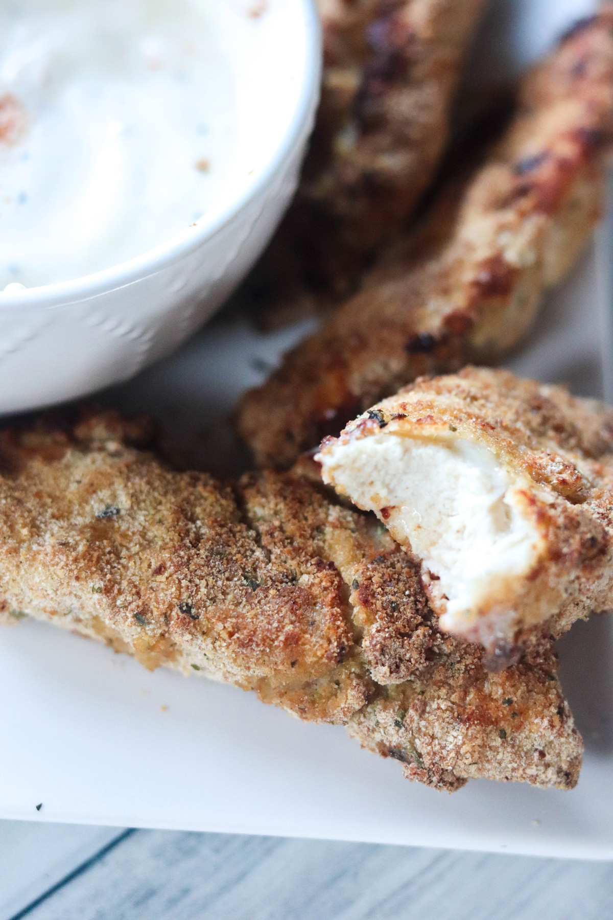 Air Fryer Chicken Fingers With a Bite Missing